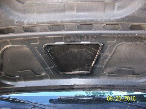 2002 Ford Crown Victoria - The underside of a car hood shows a rough, cut-out opening. A date stamp reads 09/20/2010.