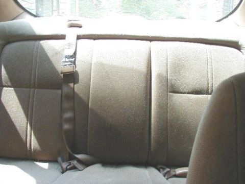 1997 Ford Taurus - Interior view of a car's rear seat and seatbelt.