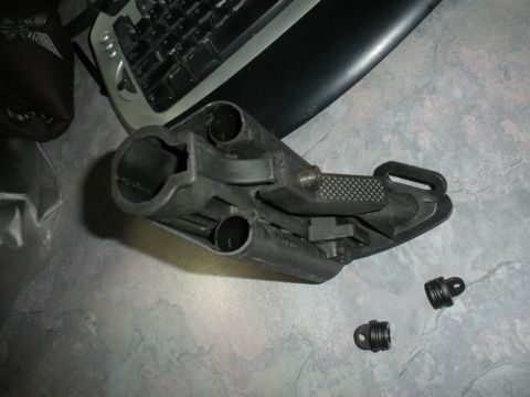 1996 Ford Bronco - Close-up of a firearm lower receiver and accessory parts on a desk surface.