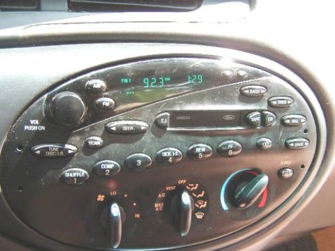 1997 Ford Taurus - Close-up of a car's center console, showing the radio and climate control knobs.