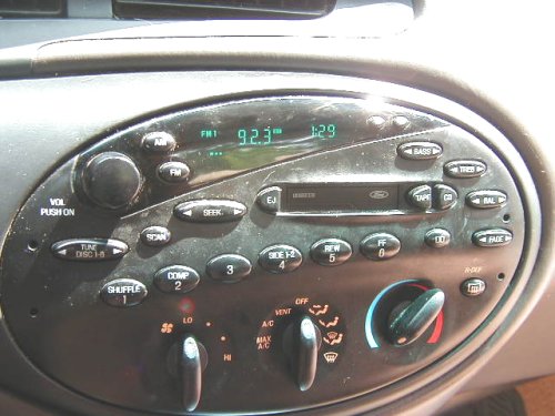 Ford factory cassette radio and climate controls in a gray oval center stack