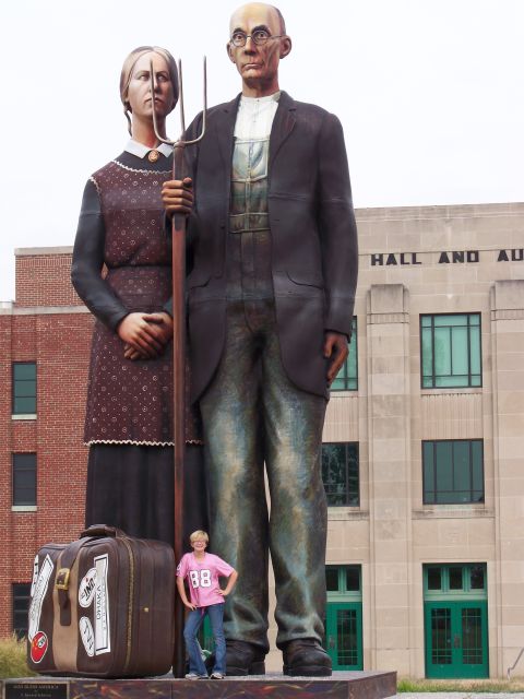 1989 Ford Bronco - A statue inspired by Grant Wood's 'American Gothic' stands tall with a small person for scale.