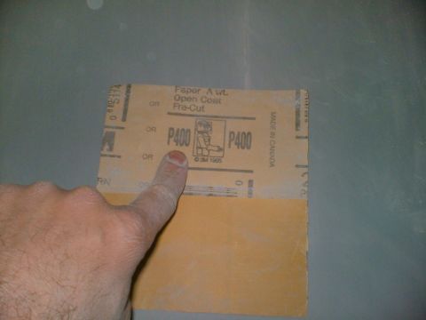 1989 Ford Bronco - A hand points to a piece of P400 grit sandpaper, indicating its grit size and type.
