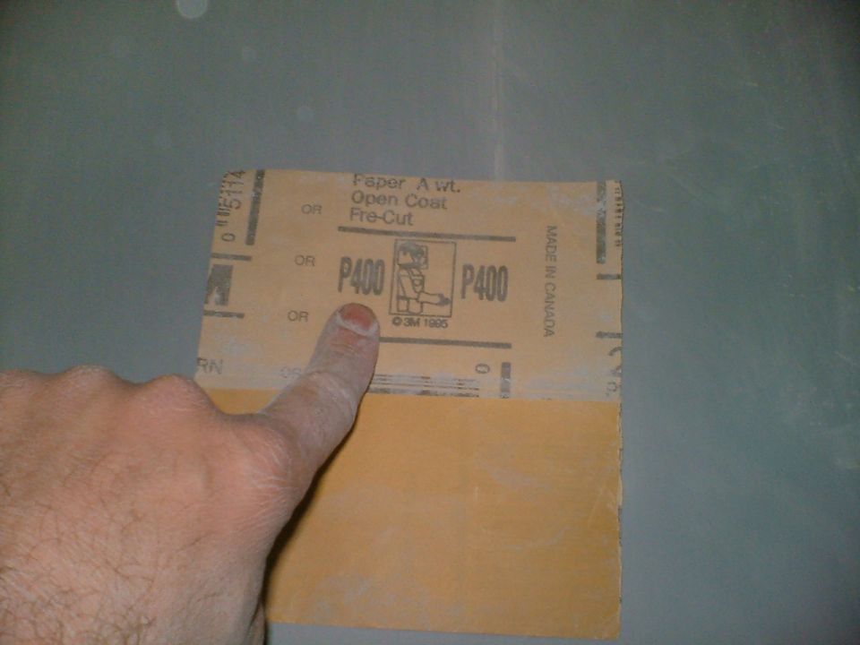 Finger pointing at a piece of P400 grit sandpaper. Text says 'Paper A wt. Open Coat Pre-Cut'