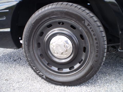 2003 Ford Crown Victoria - Close-up of a 2003 Ford Crown Victoria wheel and tire assembly.