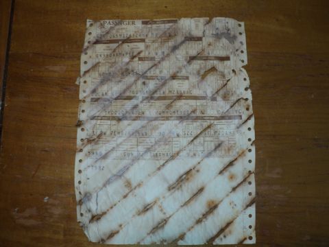 1974 Ford Elite - A worn and stained vehicle registration document lies on a wooden surface.
