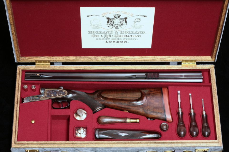 Cased Holland & Holland double-barrel shotgun with tools in red-lined oak box