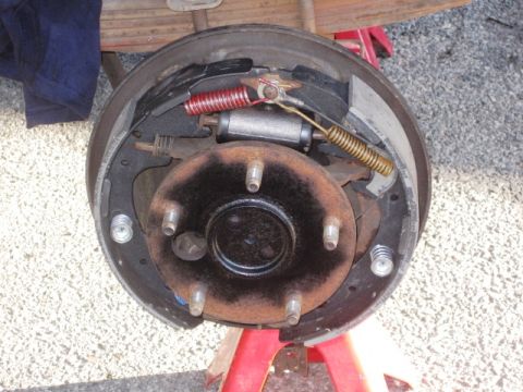 1986 Ford Bronco - Close-up of a vehicle's drum brake assembly, showing internal components.