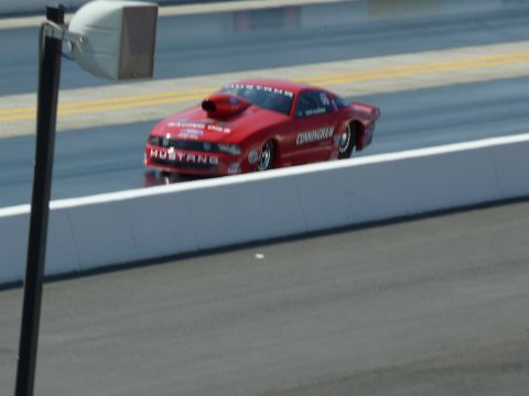 1992 Ford Mustang - A red drag racing car speeds down the track, displaying 'Mustang' and 'Cunningham' on its side.
