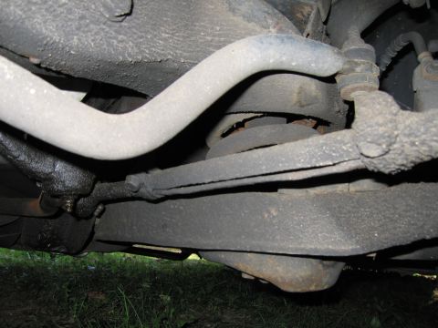 1991 Ford LTD Crown Victoria - Close-up of the vehicle's front suspension system, showing various mechanical components.