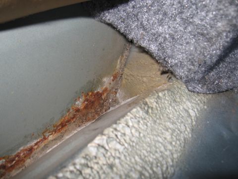 1991 Ford LTD Crown Victoria - Rust is visible on the interior metal panel of a vehicle.