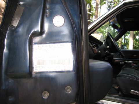 1991 Ford LTD Crown Victoria - Interior view of a 1991 Ford Crown Victoria LTD, showing the door jamb with the VIN sticker and part of the cabin.