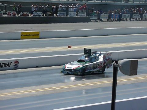 1992 Ford Mustang - Funny car drag racer competes on a track, with spectators in the background.
