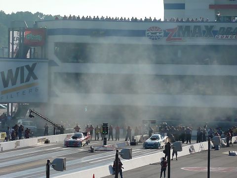 1992 Ford Mustang - Drag racing event with two cars on the track and a crowd watching.