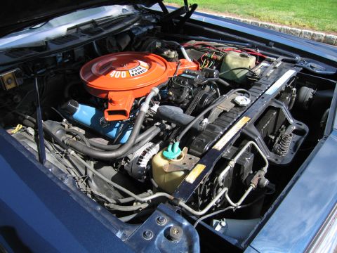 1991 Ford LTD Crown Victoria - vintage V8 engine bay with a bright orange air-cleaner housing reading '400 Four Barrel', alternator and hoses visible under an open hood.