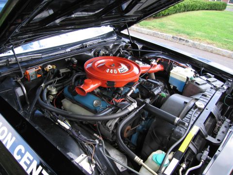 1991 Ford LTD Crown Victoria - engine bay showing an orange '440' air-cleaner housing atop a blue V8 block with hoses and reservoirs under a raised hood.