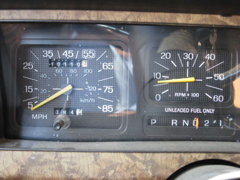 1986 Ford Bronco - The dashboard gauges and gear selector are visible in this interior shot.