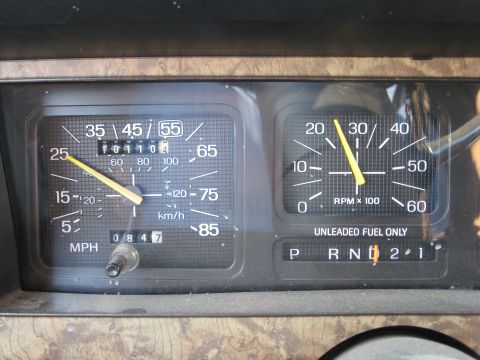 1986 Ford Bronco - The dashboard gauges show the vehicle's speed, mileage, and engine RPM, along with the gear selection.