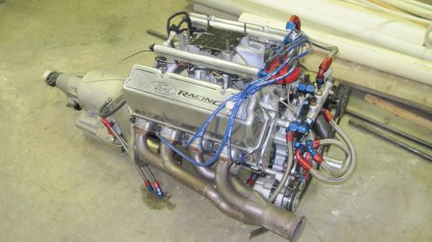 1992 Ford Mustang - A Ford Racing V8 engine is shown connected to a transmission, with custom exhaust headers and fuel lines.