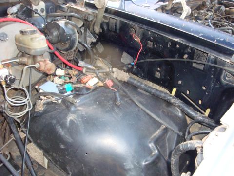 1989 Ford Bronco - Engine bay of a 1989 Ford Bronco with visible brake booster and wiring.
