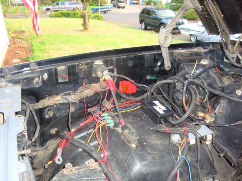 1989 Ford Bronco - The engine bay is filled with a complex wiring harness and a Superwinch control box.