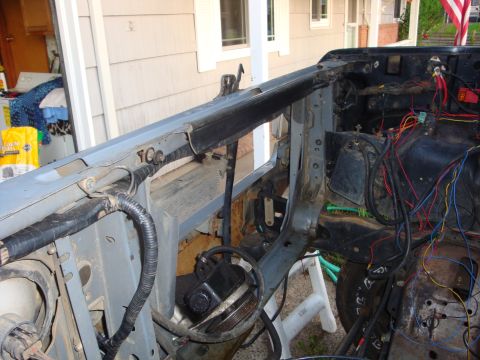 1989 Ford Bronco - The engine bay of a vehicle is shown with exposed wiring and components, suggesting a repair or modification process.