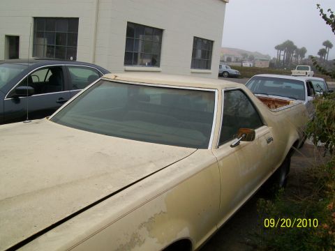 1978 Ford Ranchero - A 1978 Ford Ranchero is parked in front of a building with other vehicles nearby.