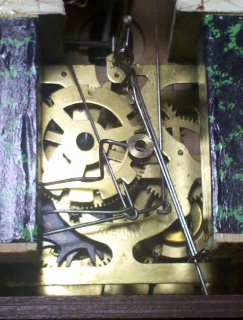 1978 Ford Bronco - The intricate gears and levers of a clock mechanism are visible, with 'GERMANY' marked on the brass plate.