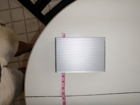 2007 Dodge 2500 - A silver electronic component with a ribbed surface is shown with a pink measuring tape for scale.