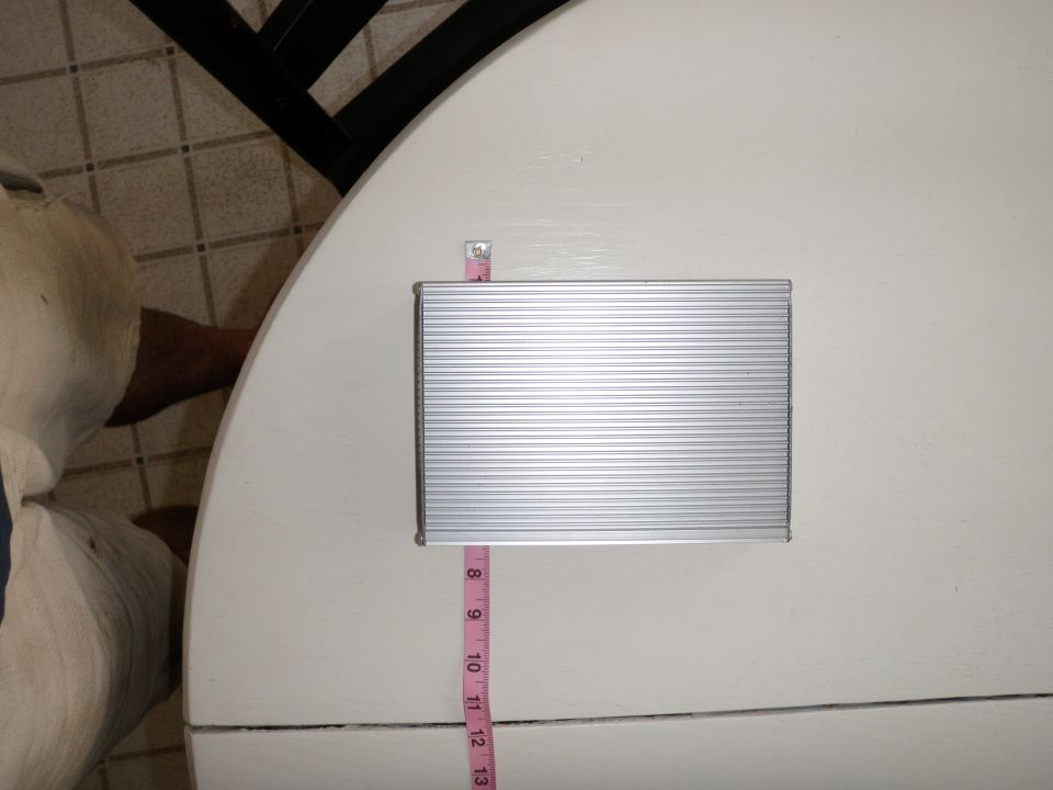 Silver ribbed electronic part with pink measuring tape