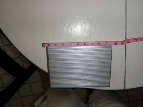 2007 Dodge 2500 - Object with horizontal ridges is being measured with a pink tape measure.