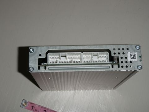 2007 Dodge 2500 - Close-up of a car audio amplifier, showing its connectors and a measuring tape for scale.