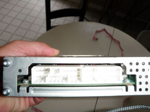 2007 Dodge 2500 - A car stereo wiring harness is shown, with its connectors and metal casing visible.