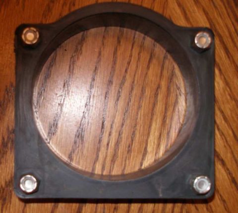 1997 Ford Taurus - This is a rubber gasket, likely for an air intake or throttle body, shown on a wooden background.