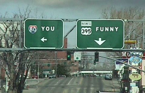 1995 Ford Bronco - Road signs direct traffic towards 'YOU' and 'FUNNY' destinations.