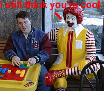 1995 Ford Bronco - A man sits with a Ronald McDonald statue, both appearing to be indoors near a window.