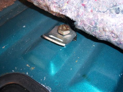 1996 Ford Bronco - Close-up of a child seat tether anchor bolt installed in the interior of a 1996 Ford Bronco.