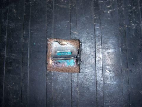 1996 Ford Bronco - Interior view of a car's floor with a child seat tether anchor point visible.
