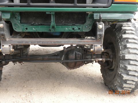 1989 Ford Bronco - Close-up of front axle and suspension components on a modified off-road vehicle.