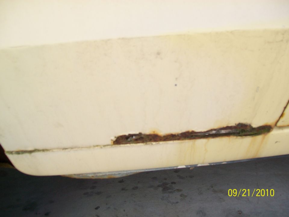 Cream 1978 Ford Ranchero lower body panel with extensive rust
