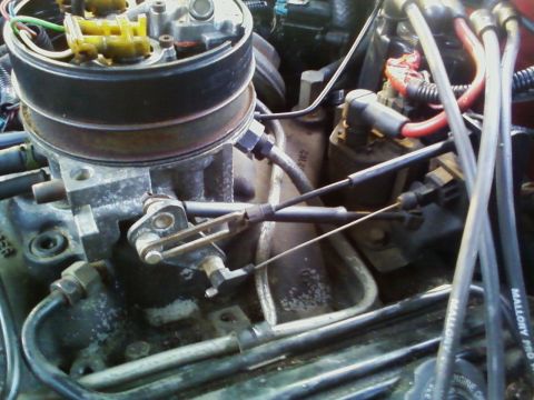 1989 Chevrolet Camaro - Close-up view of engine components, including a throttle body and Mallory spark plug wires.