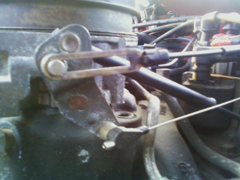 1989 Chevrolet Camaro - Carburetor linkage detail, showing the throttle cable mechanism.