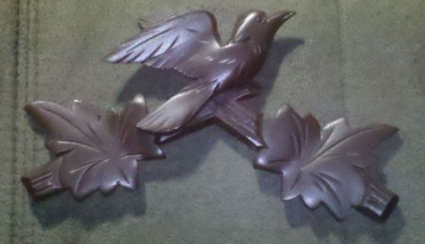 1978 Ford Bronco - This decorative carving features a bird in mid-flight, flanked by two stylized leaves.