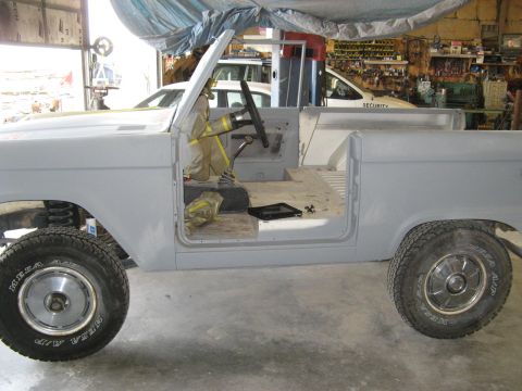 1966 Ford Bronco - This 1966 Ford Bronco is undergoing restoration work in a garage, with its interior partially disassembled.