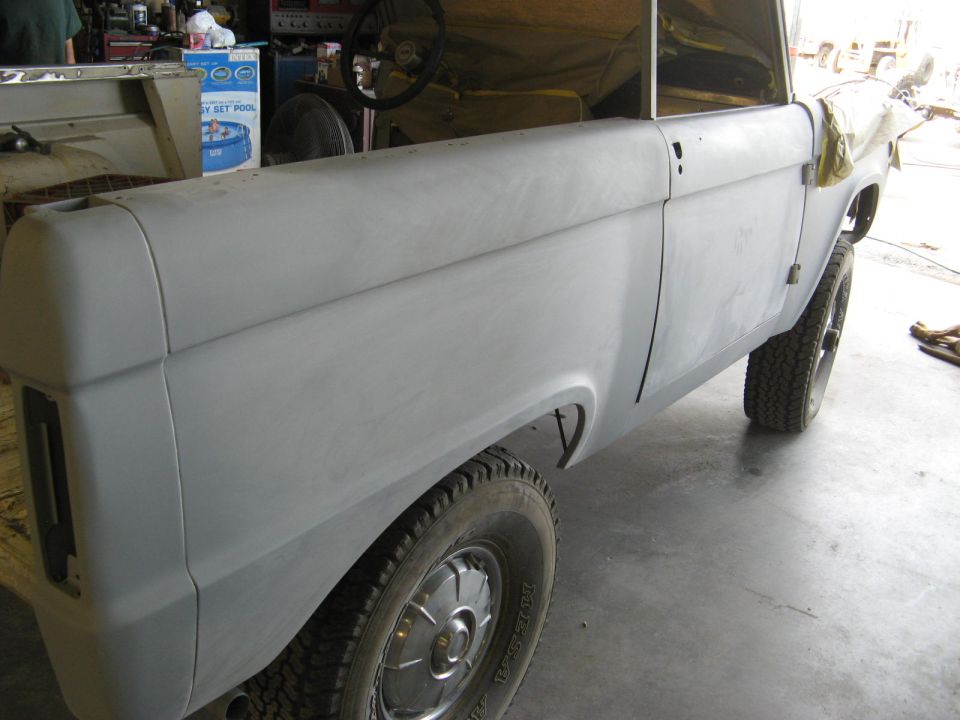1966 Ford Bronco body in primer, side view, showing fender and door