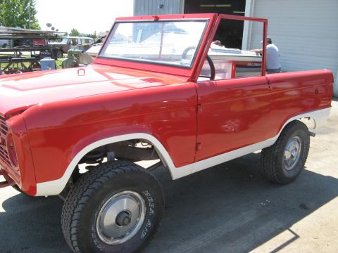 1966 Ford Bronco - This 1966 Ford Bronco is shown in a 3/4 front view, a red body with white accents.