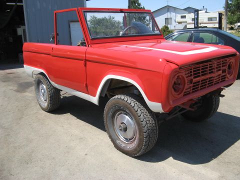 1966 Ford Bronco - This 1966 Ford Bronco is painted red with white accents and a stripe on the hood.