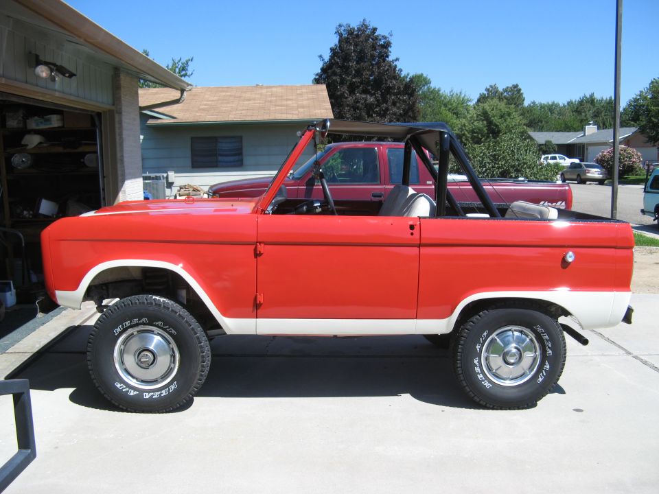 Red and white 1966 Ford Bronco side view