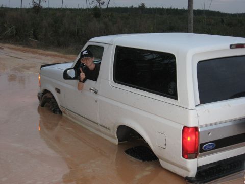1994 Ford Bronco - Driver gives a thumbs up from a 1994 Ford Bronco stuck deep in mud.