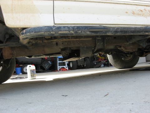 1994 Ford Bronco - Underside view of a white 1994 Ford Bronco, revealing its chassis and mechanical components.